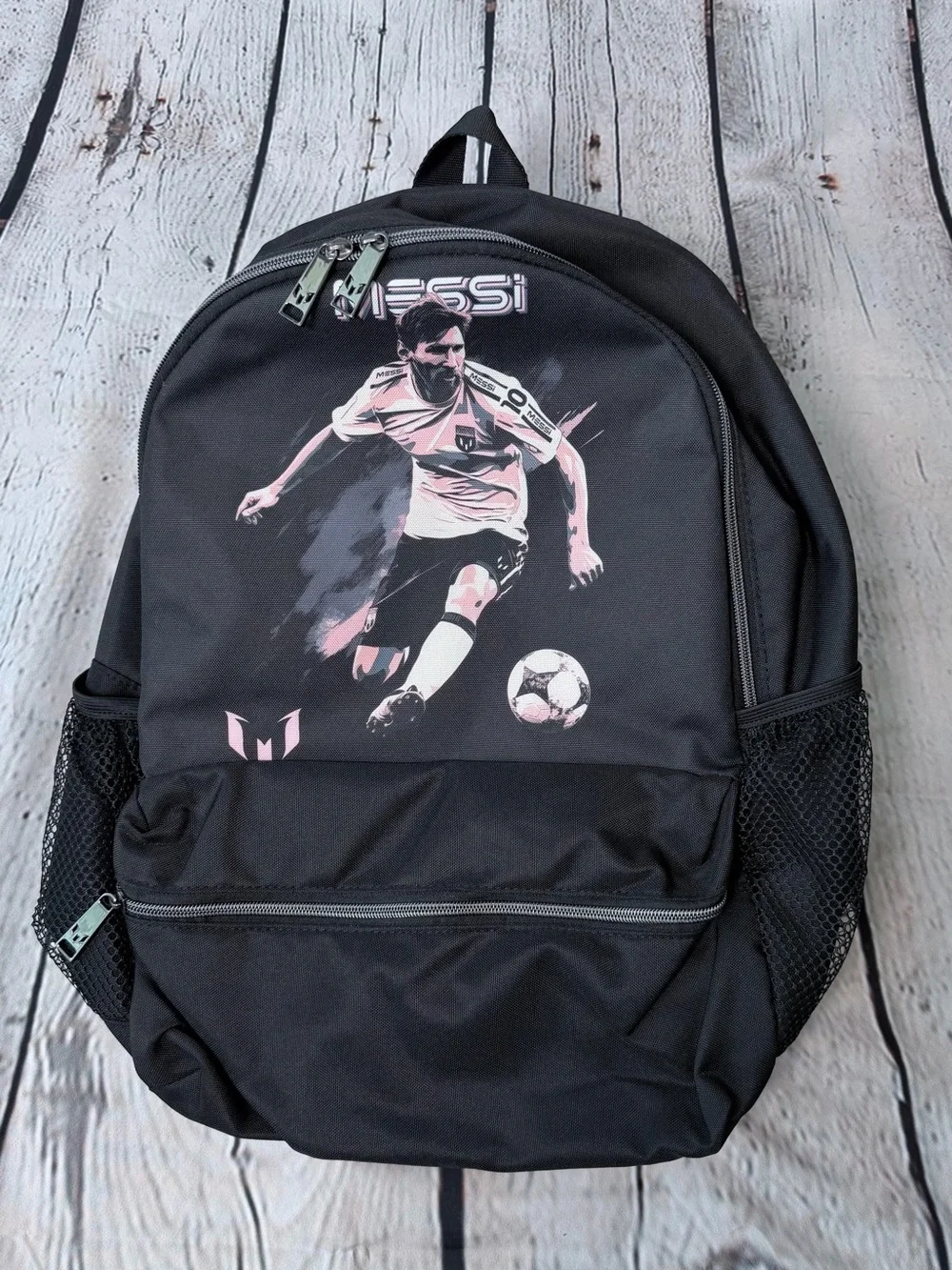 Black Messi backpack with graphic of a soccer player in action